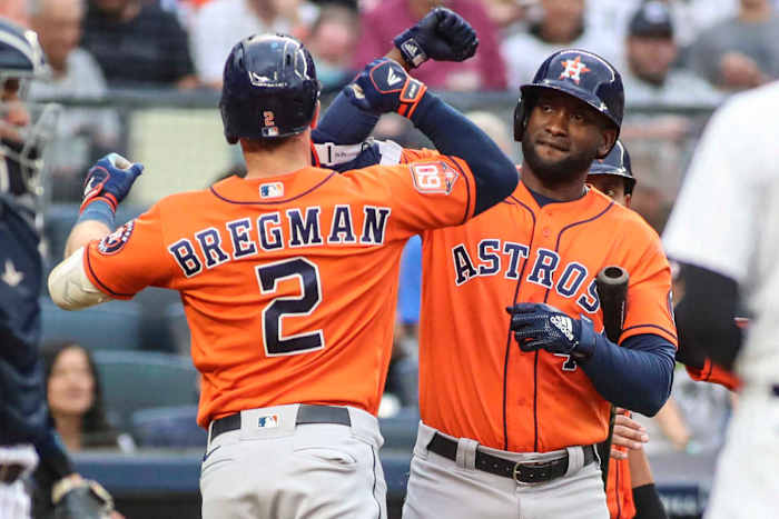 Houston Astros left fielder Yordan Álvarez celebrates with teammate Alex Bregman.
